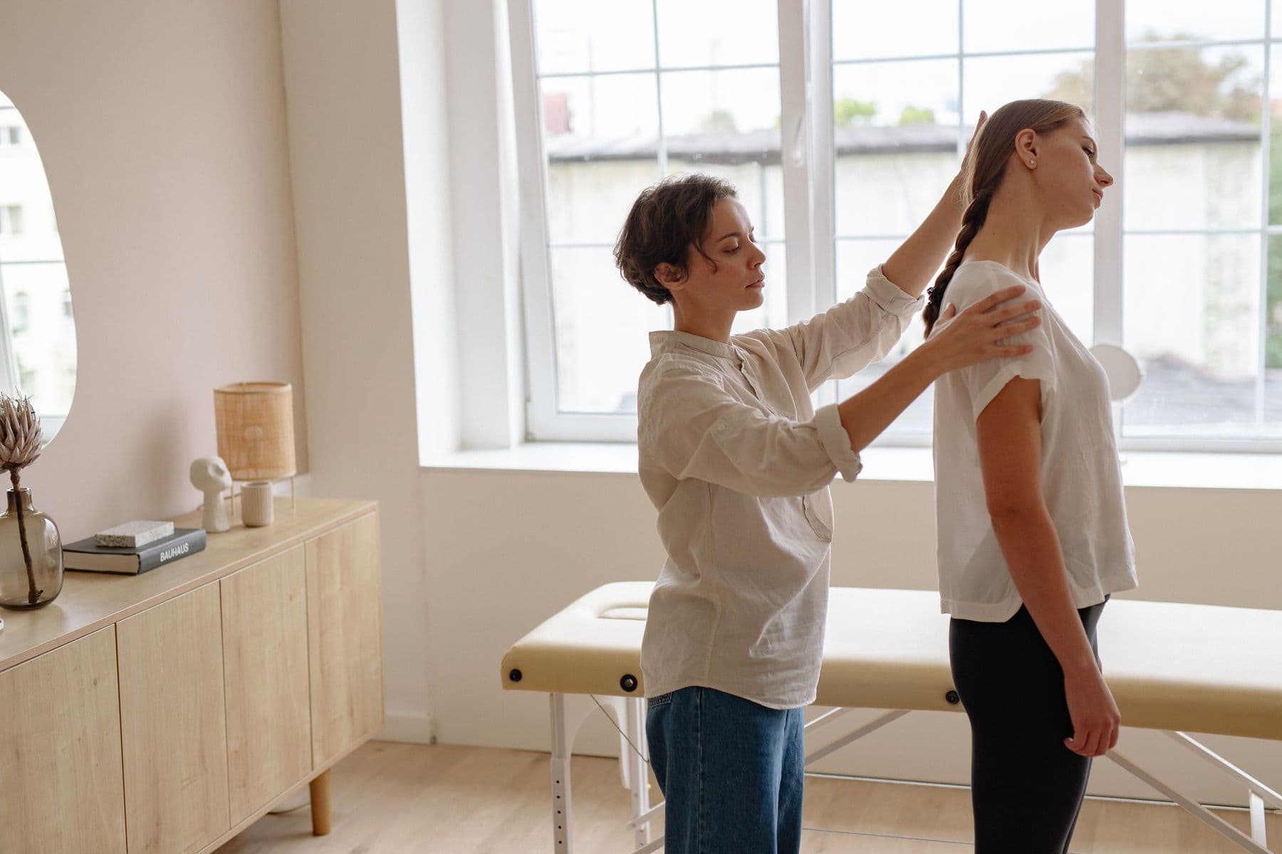 Posture assessment in a bright, natural-light treatment room