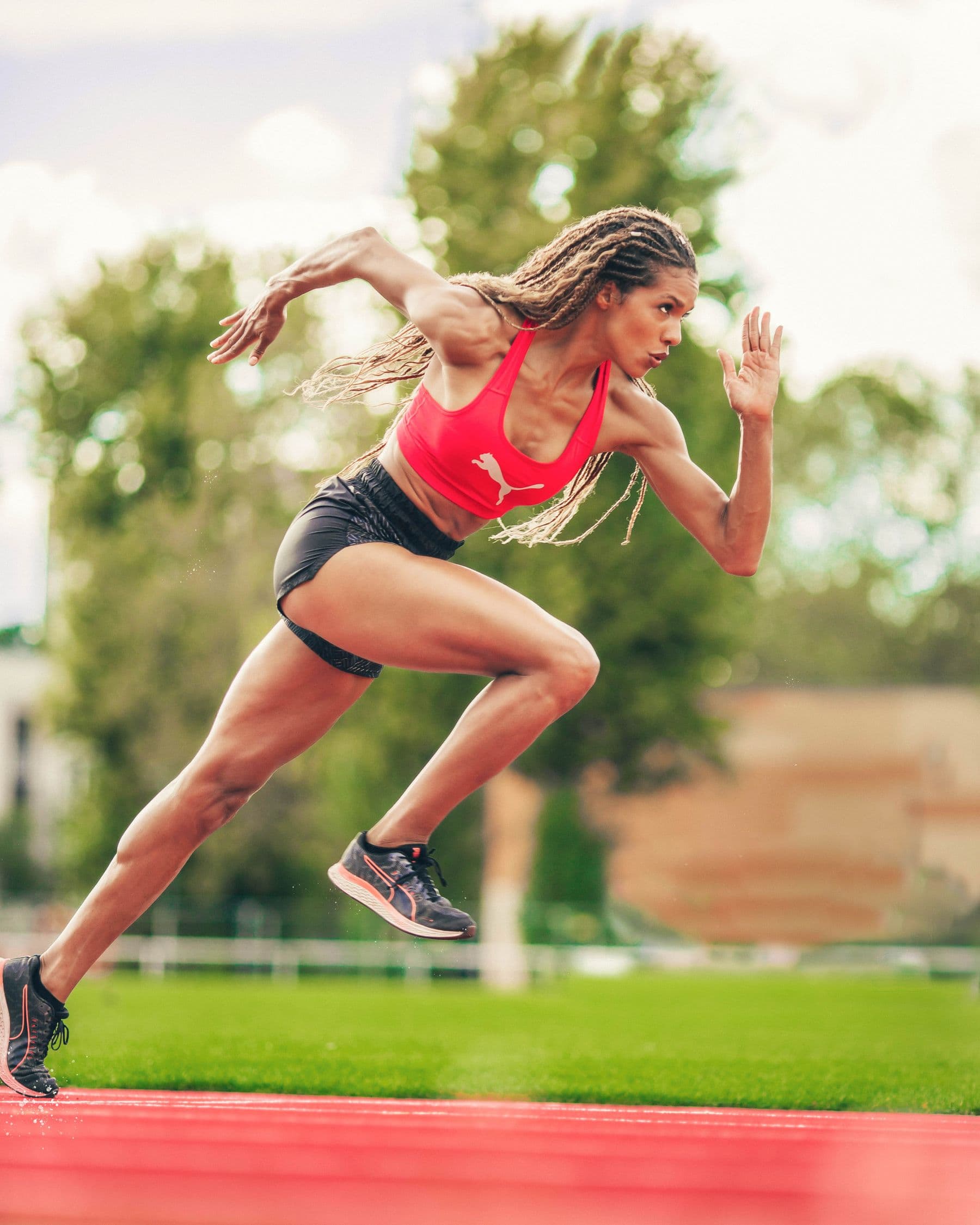 Athlete driving out of a sprint start on an outdoor track