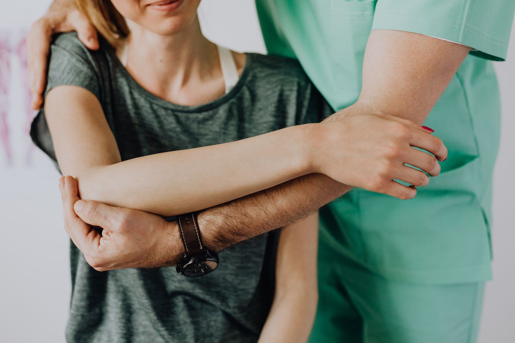 Close-up of hands-on shoulder mobilization during treatment