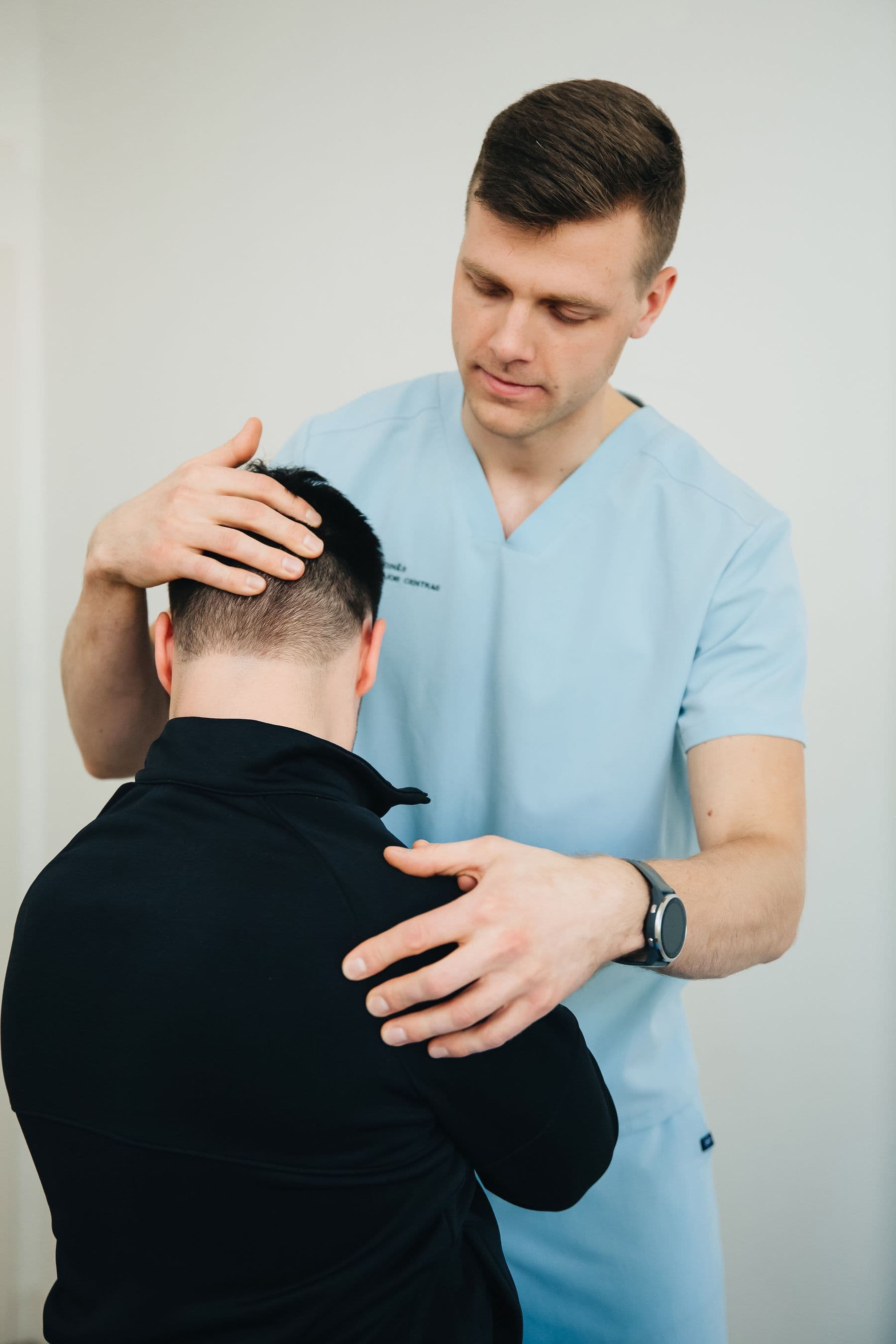 Clinician performing a focused cervical examination